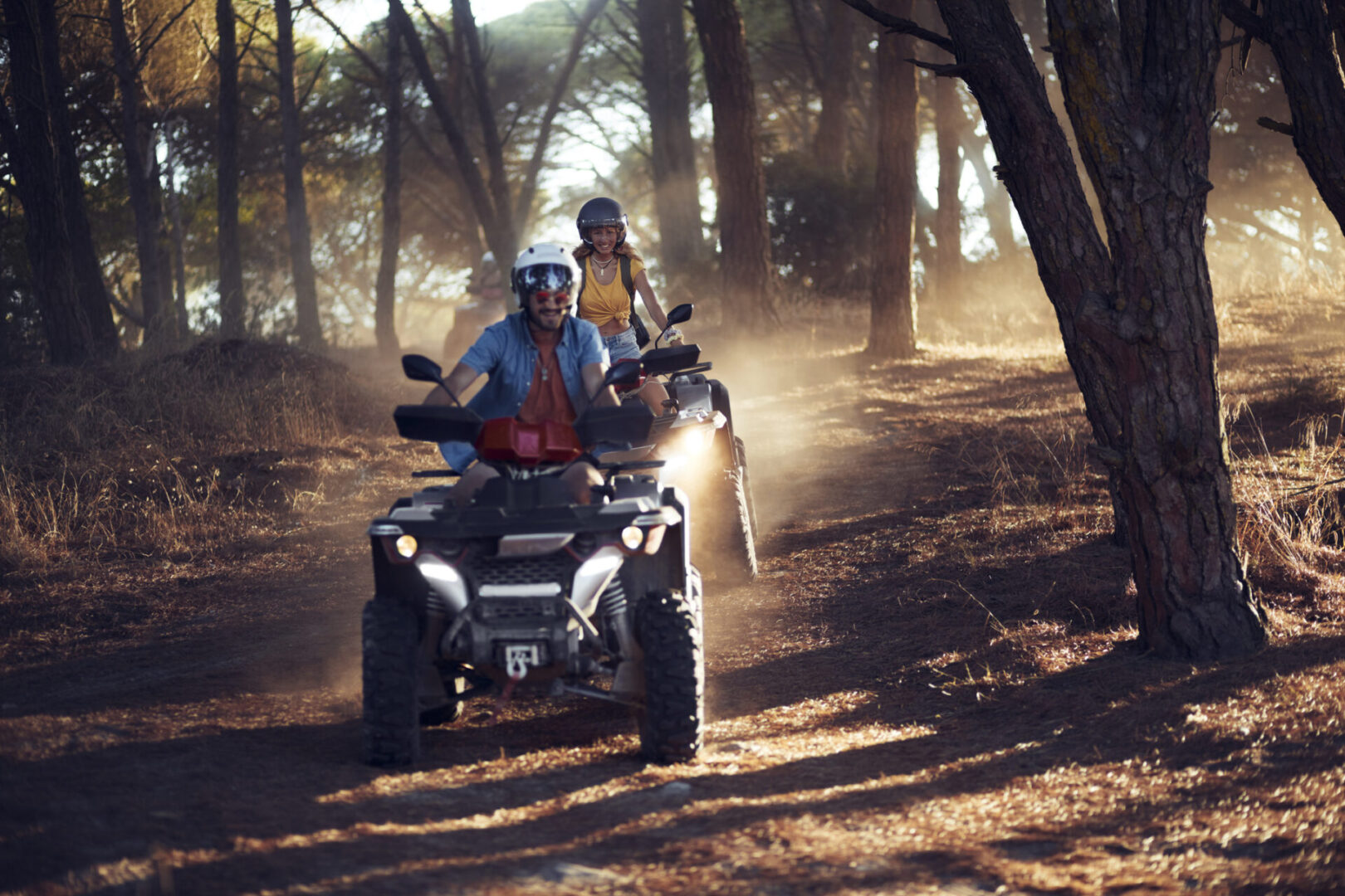 Two people enjoying ATV ride in woods