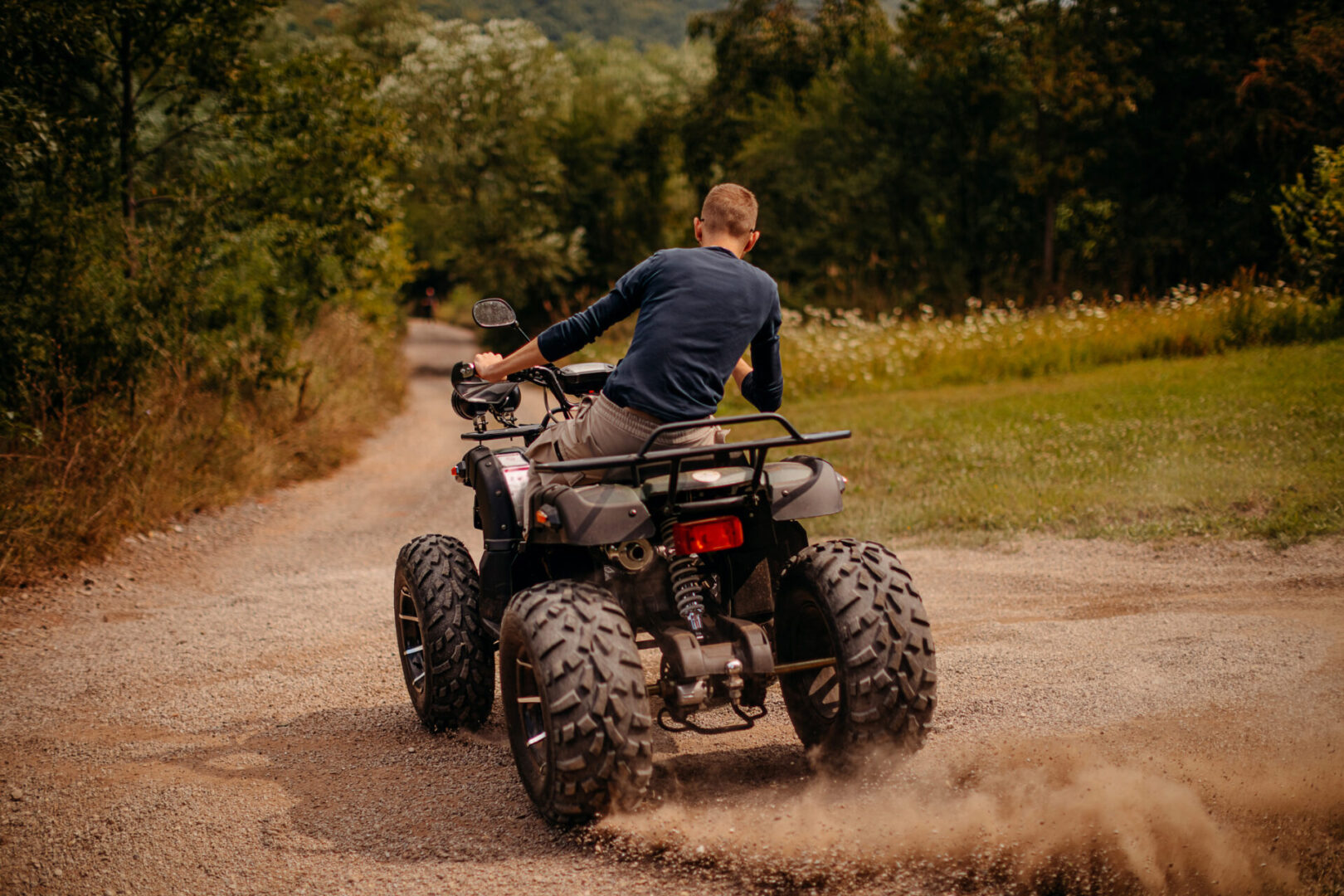 Man driving quad bike in nature