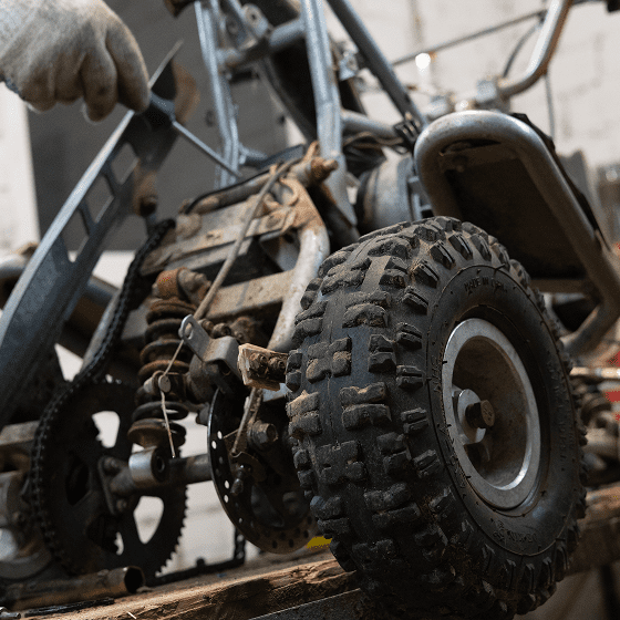 Close-up of rugged vehicle tires and engine